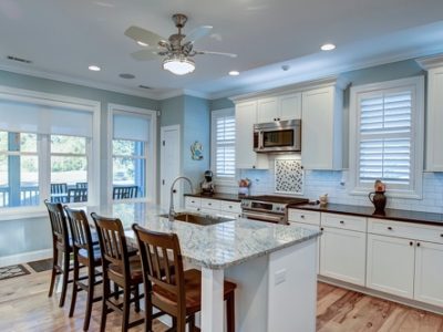 Best Custom Windows For Improved Natural Light in St. Tammany Parish with Northshore Renovations & Contracting; image of bright white open kitchen with 6 windows in total