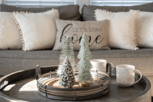 How To Winterize Your Home Inside And Out with Northshore Renovations and Contracting in Madisonville, LA; image of decorated couch and coffee table with winter decorations with coffee mugs