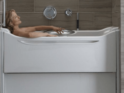 Benefits of Accessible Bathtubs with Northshore Renovations and Contracting. Image of older woman relaxing in her walk in tub by Kohler