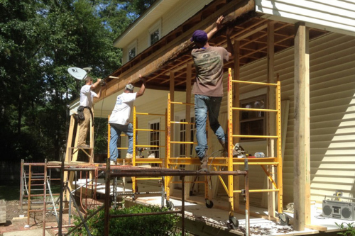 Tips When Hiring a Contractor for Custom Painting Renovations in Madisonville, Mandeville, and Covington, LA | Northshore Renovations. Image of three men doing a custom painting job outside a house.