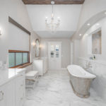 modern bathroom renovation has new ceramic tile, bathtub and vanity installed