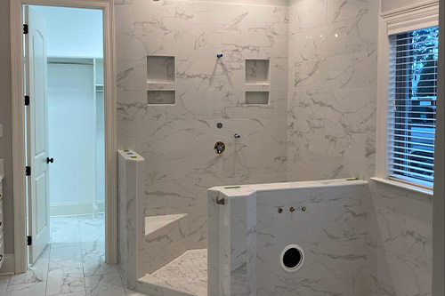 Surprise Bathroom Renovation Guide | Northshore Renovations & Contracting, LLC. Image of brand new marble luxury bathroom renovation done by Northshore Renovations & Contracting.